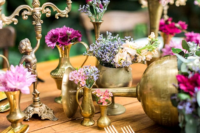 Vintage brass vessels filled with flowers