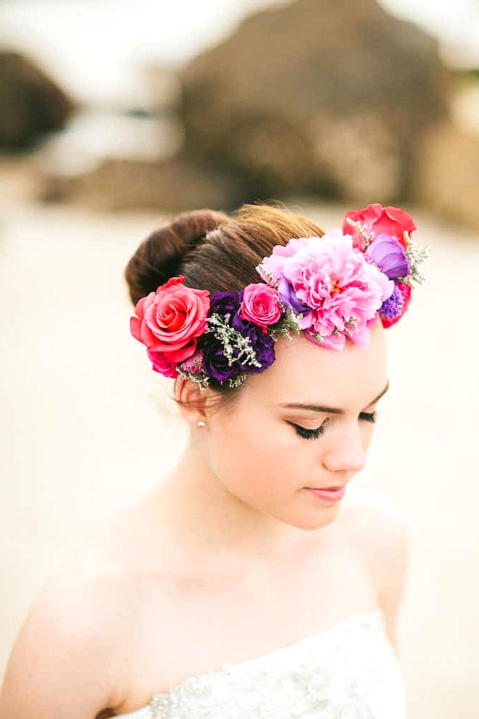 Elegant beach bride wearing bright flower crown