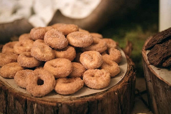 Wedding dessert table doughnuts on wood rounds