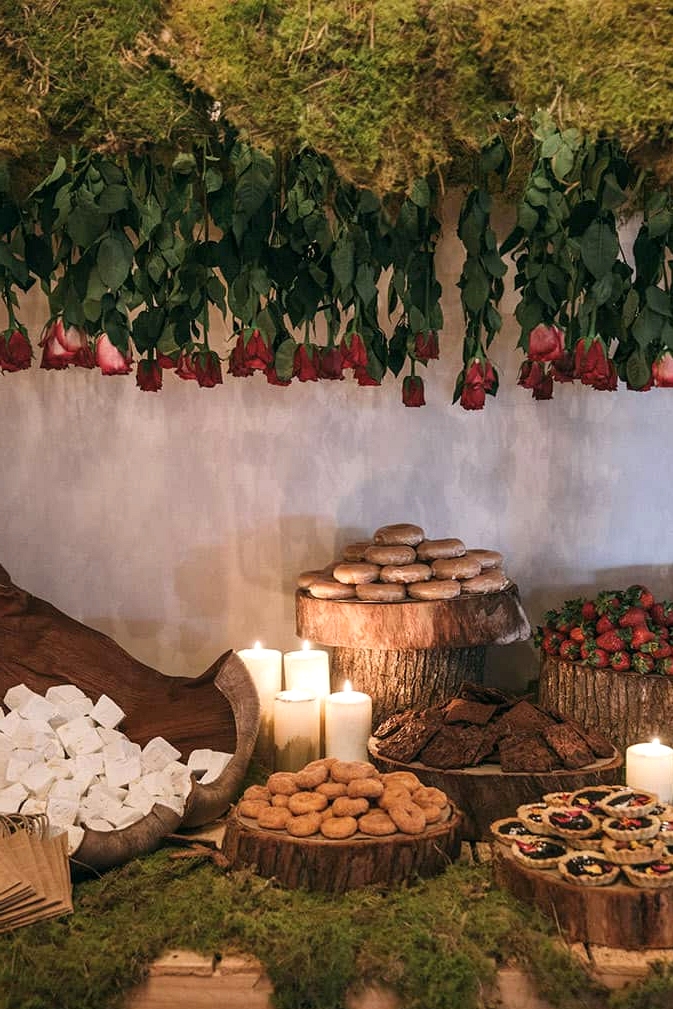 Wedding dessert table styling with moss and wood rounds