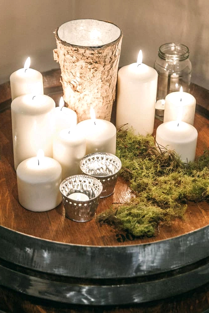 Wedding reception candle display on wine barrel