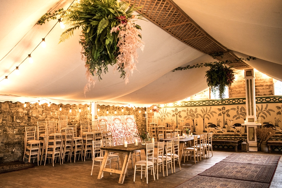 Eoin & Darran Real Wedding interior photography tent overhanging flowers floral design chairs dining dance floor