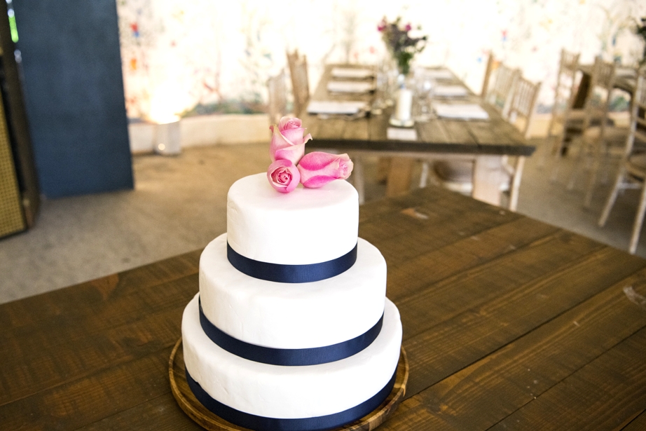 Eoin & Darran Real Wedding cake flowers roses ribbon interior tent shot