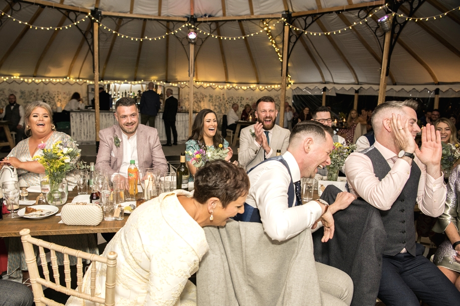 Eoin & Darran Real Wedding guests happy laughing smiling interior tent dining