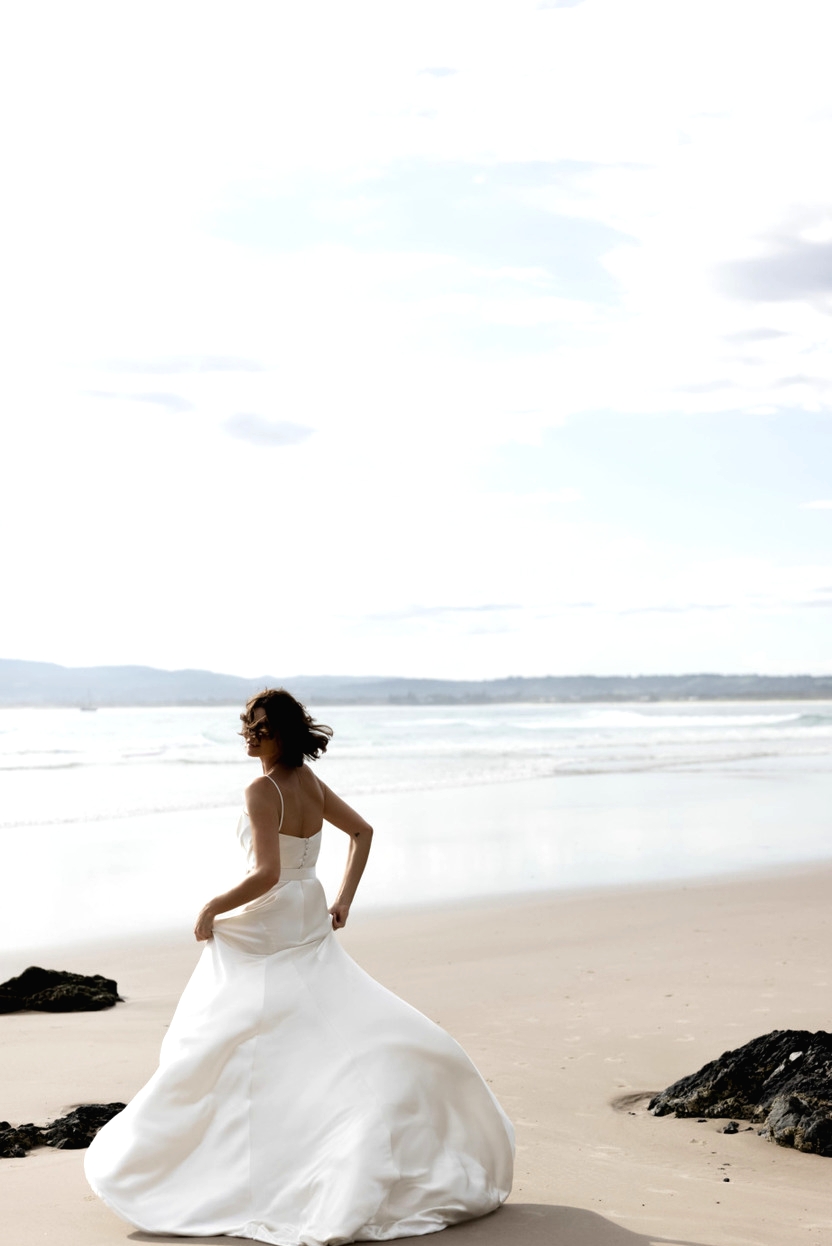 Bride running on beach silk wedding dress Karen Willis Holmes