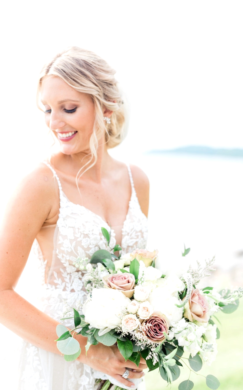 bride smiling holding bouquet