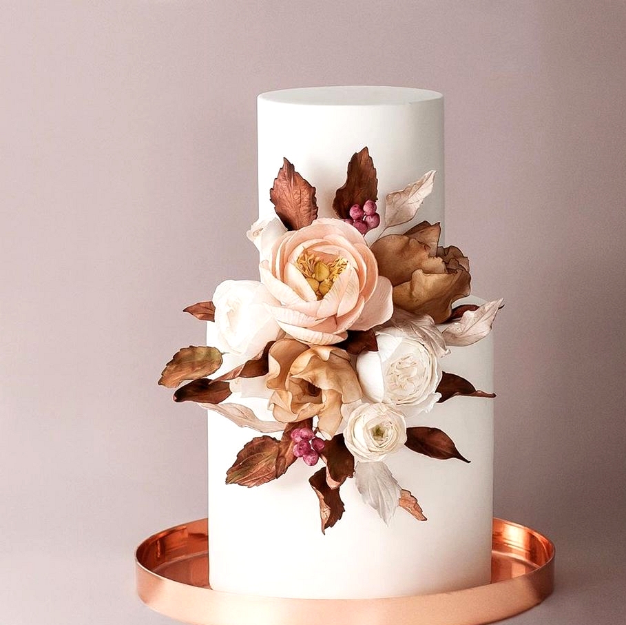 autumnal wedding cake with fall blooms and cooper stand