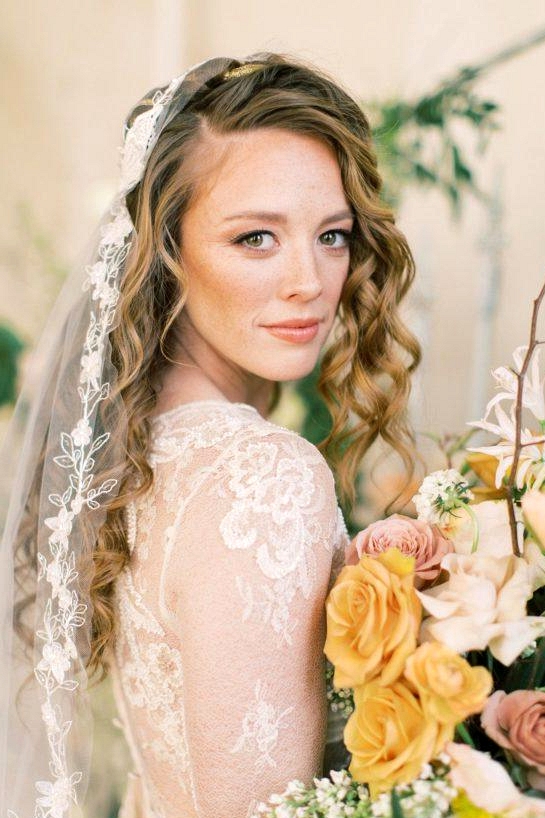 vintage lace wedding dress with a floral appliqué bridal veil