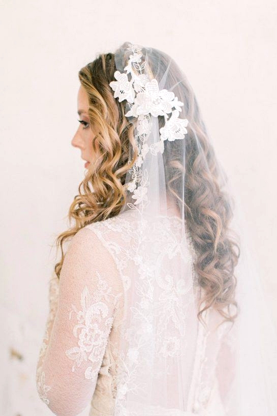 vintage lace wedding dress with a floral appliqué bridal veil