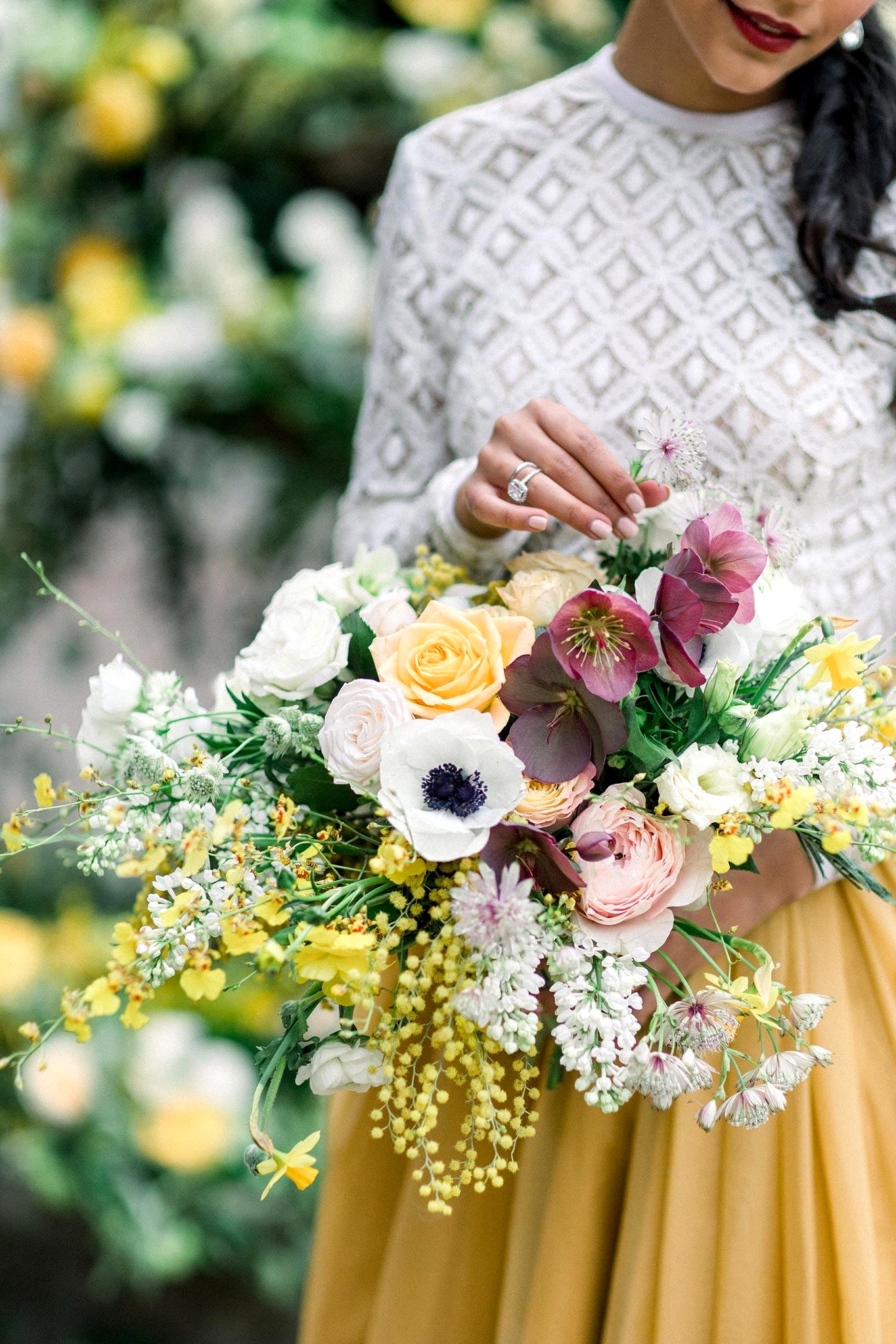 crochet lace top and mustard bridal skirt in this two piece wedding dress look with a colorful spring garden bouquet