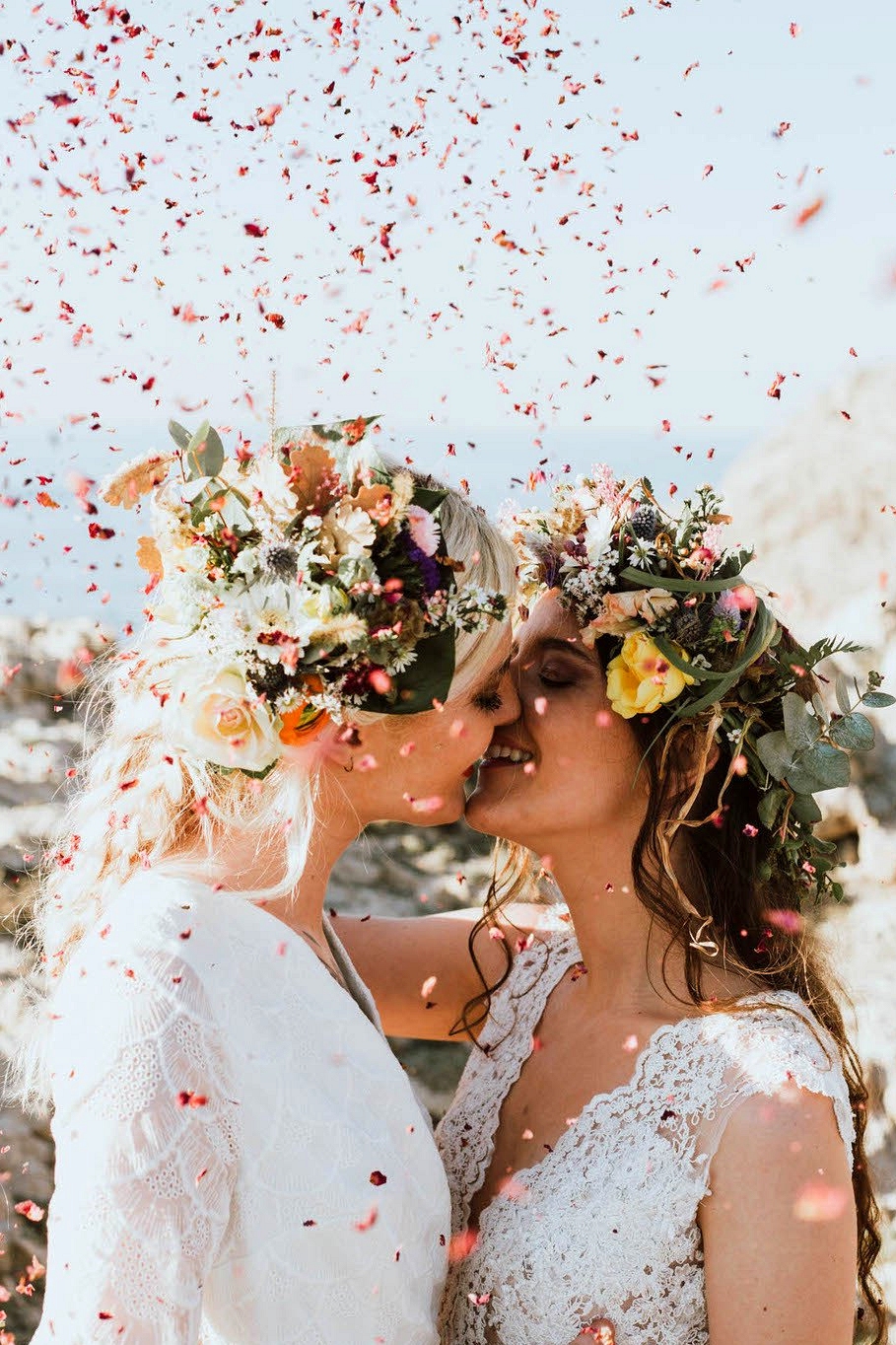 brides kiss as confetti falls around them