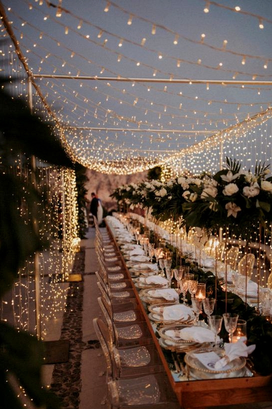 fairy light canopy at the reception begins to glow as it turns to night