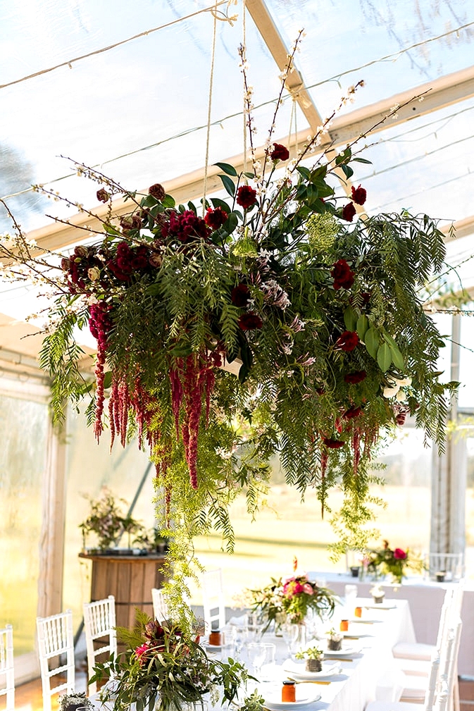 Rustic farm marquee wedding reception with burgundy flowers | Gemma Clarke Photography