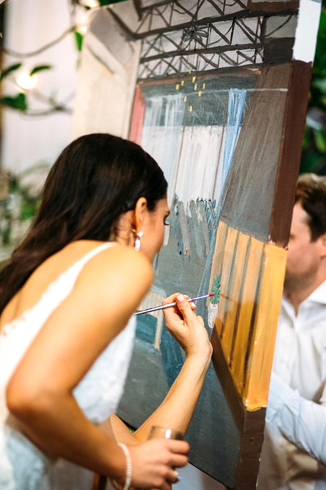 Guests painting wedding scene on canvas | Wildflower Weddings