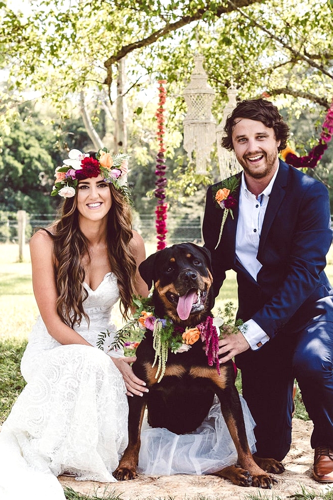 Bright tropical boho wedding bride and groom with dog wearing floral collar and tutu | Red Berry Photography
