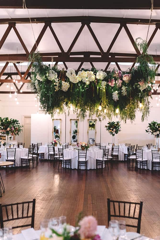 Romantic wedding reception in vintage dining room with floral dance floor canopy | Vanessa Norris Photography