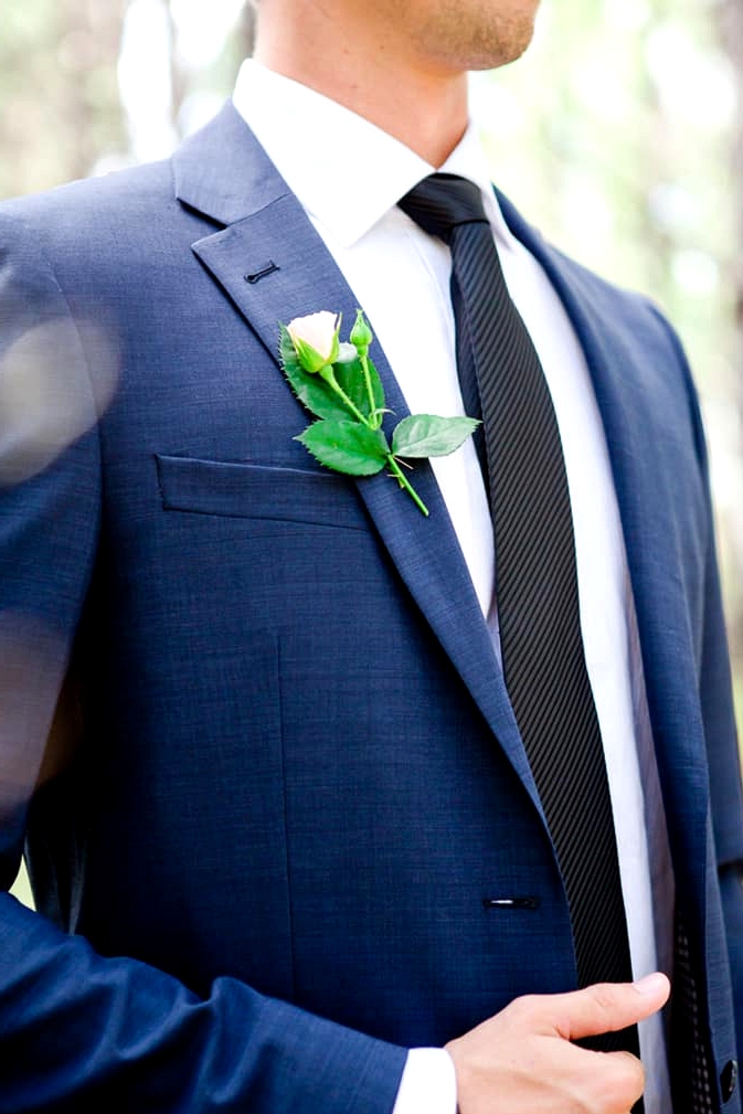 Navy suit with pink rose boutonniere