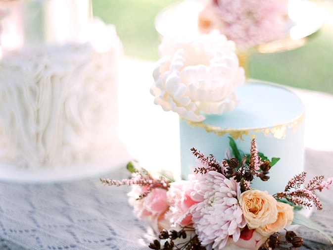 Soft blue wedding cake with gold foil and sugar peony