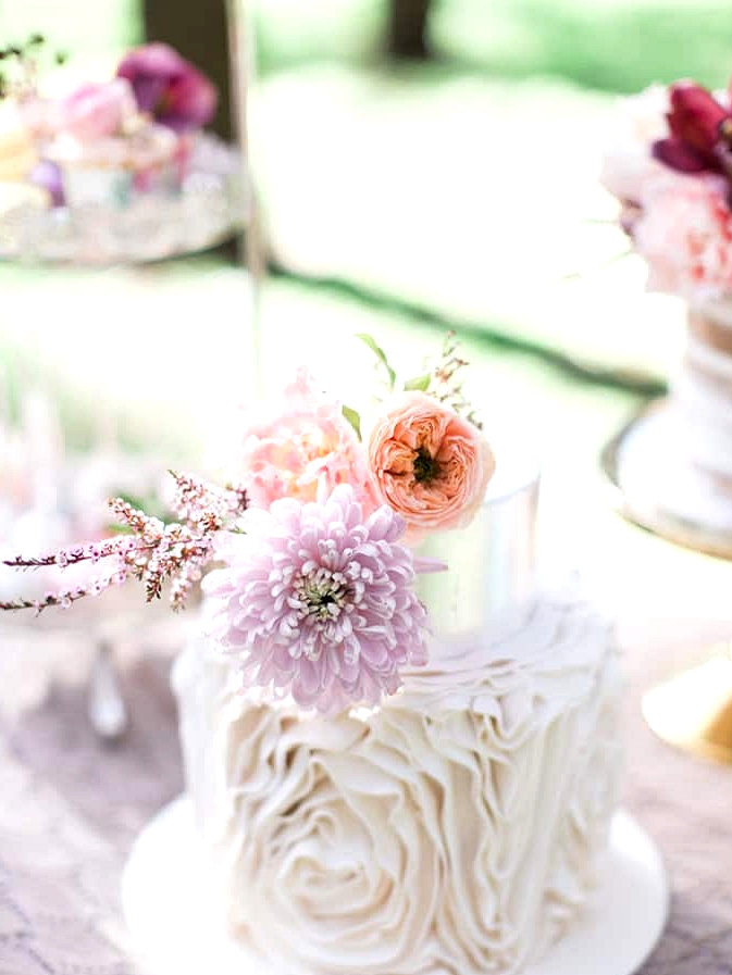 Ruffle wedding cake with silver tier and pastel flowers