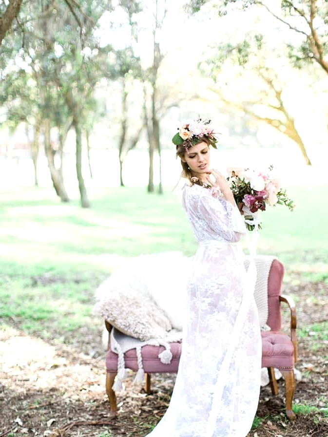 Bohemian bride wearing lace robe with romantic florals