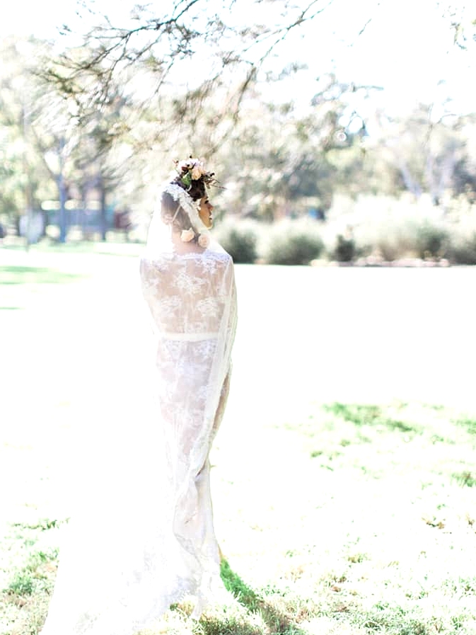 Boho bride wearing lace robe and veil