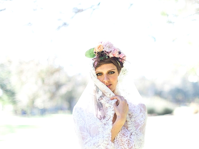 Boho bride wearing lace veil and flower crown